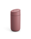 The Fellow Carter Slide Mug, a pink reusable travel cup with a rounded lid, on white background.