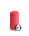 A Coral Crush Fellow Carter Move Mug with a metallic lid sits in front.