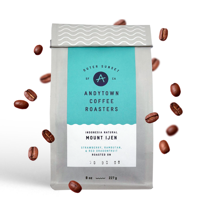 A bag of Andytown Coffee Roasters Indonesia Natural Mount Ijen with coffee beans floating around.