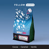 A vibrant Impact USA coffee bag by Kickoff Coffee Co. with cocoa, caramel, and vanilla notes.