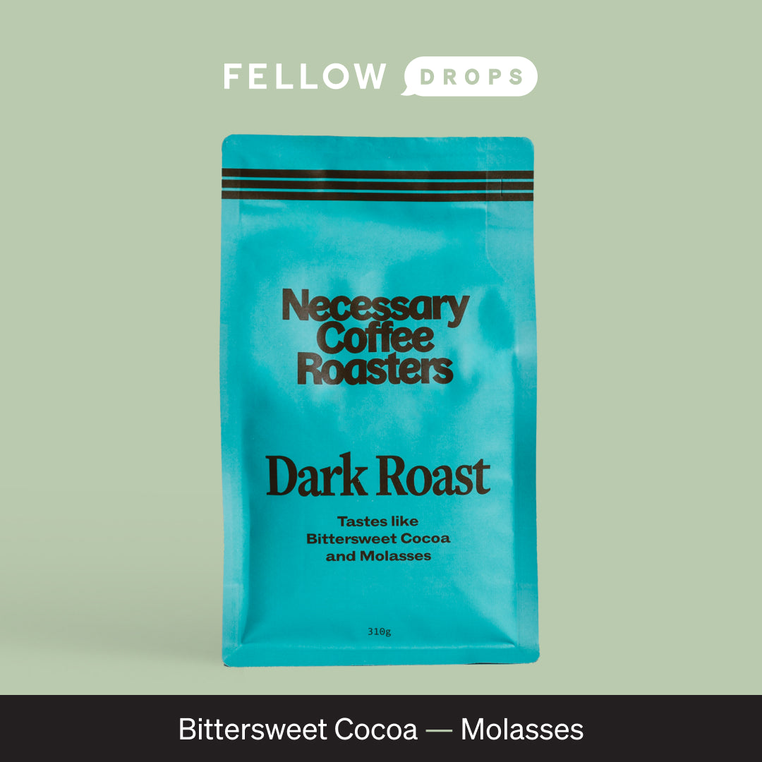 A blue bag of Necessary Dark Roast by Necessary Distribution, labeled Bittersweet Cocoa—Molasses.