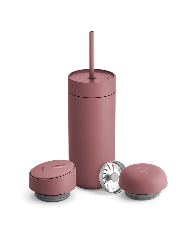 Fellow Carter 3-in-1 Lid System matte pink mug with straw and two containers on white background.