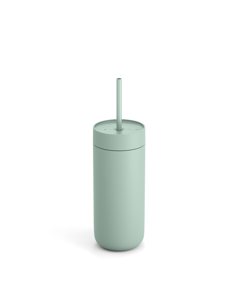 The Fellow Carter Cold Tumbler is a light green reusable cup with a lid and straw.