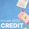 Fellow Drops Credit by Fellow, shown with two coffee bags on a blue background.